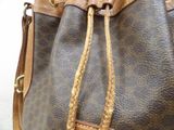 a brown and tan handbag with a brown handle