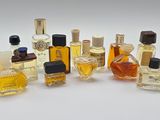 many different types of perfume bottles on a white surface