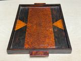 a small wooden box with a design on it