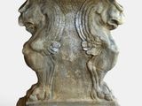 a stone pedestal with a lion and a lion head on it