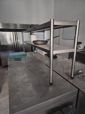 a kitchen with stainless steel counter tops and stainless steel shelves