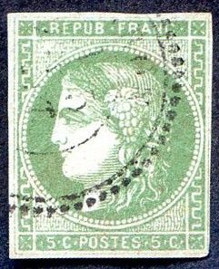a green stamp with a woman ' s face on it