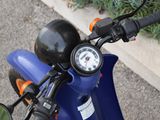 a close up of a motorcycle with a gauge on the handlebars