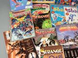 a lot of comic books that are on the table