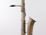 a close up of a saxophone on a white surface with a white background