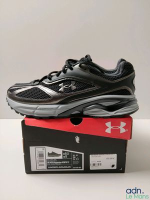 a pair of black running shoes sitting on top of a box