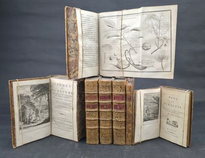 several old books are stacked on top of each other on a table