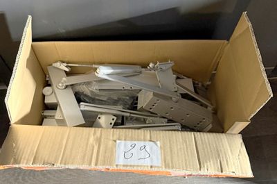 a cardboard box with a bunch of metal parts in it