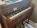 a piano that is sitting in the corner of a room