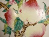 a white vase with a painting of apples on it
