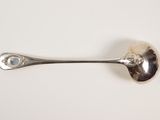 silver spoon on a white surface with a white background