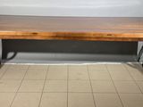 a wooden table that is sitting on a tile floor
