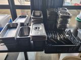 many trays of food sitting on a table