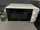 a microwave that is sitting on a counter top