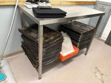 a metal table with a bunch of papers on top of it