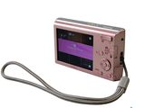 a pink digital camera with a cord attached to it