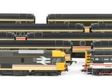 four trains that are lined up together on the tracks