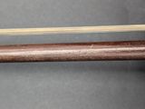 an image of a close up of a wooden stick with a string attached to it