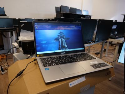 a laptop computer sitting on top of a box on a desk