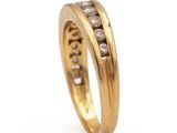 a close up of a gold ring with diamonds on a white background