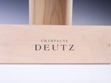 a wooden box that has a bottle of wine in it