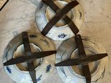 three pieces of pottery on a table with a pair of scissors on it