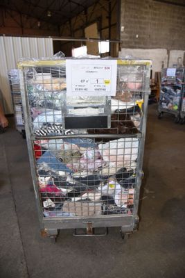 a metal cart with many items in it in a warehouse