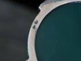 a close up view of a mirror with a reflection of a person in it