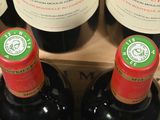 several bottles of red wine sit in a wooden box