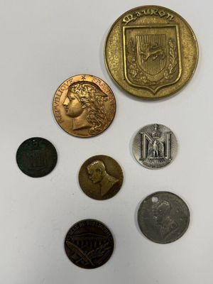 a close up of a group of coins on a white surface