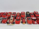 a lot of red toy cars sitting on a white surface