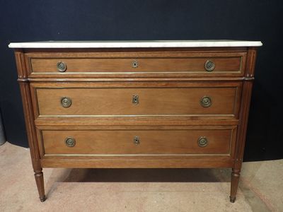 an antique chest of drawers with marble top
