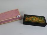 a small box with a painting on it next to a smaller box with a painting on it