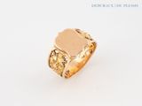 an image of a gold ring with a signet on it