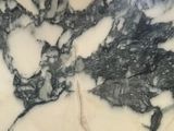 a close up of a marble counter top with a toothbrush
