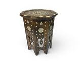 a close up of a wooden table with a flower design on it