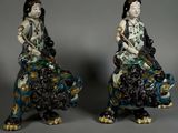 pair of asian figurines of a woman and a man on a horse