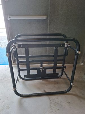 a black metal chair that is sitting in a garage