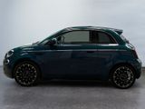 the small blue car is parked in a room with a white wall