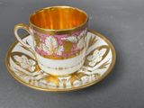 a cup and saucer on a saucer on a table