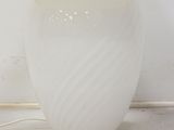 a white lamp that is sitting on a table