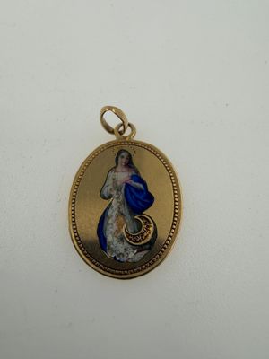 a close up of a gold locke with a blue and white image on it