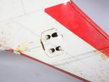 a close up of a red and white airplane wing
