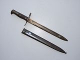 two old knives are laying on a white surface