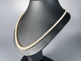 a close up of a mannequin with pearls on it