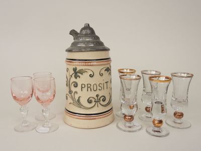 bottles and glasses are lined up on a white surface