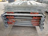 a close up of a pile of steel beams in a warehouse