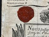 an old document with a wax seal and a stamp on it