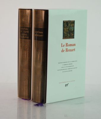two books sitting on top of a white table next to each other