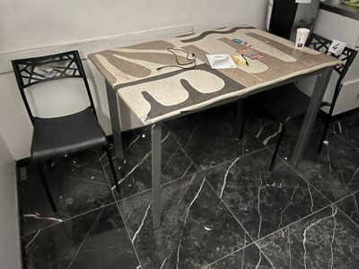 a table and two chairs in the corner of a room